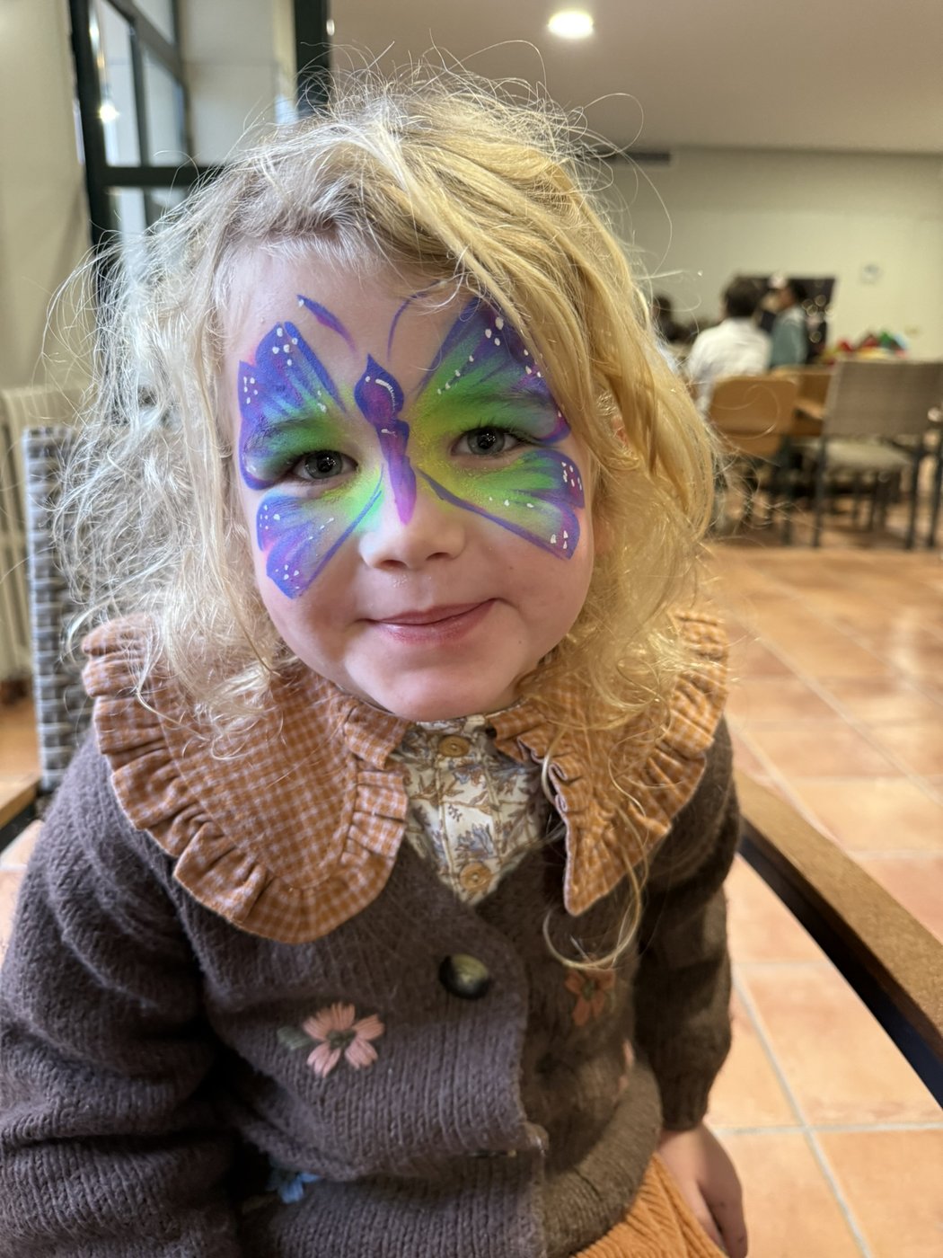 Niña con mariposa lila y verde